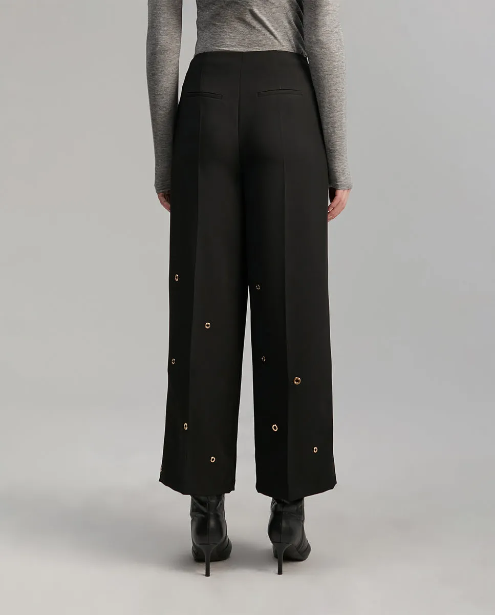 Trousers with eyelets detail